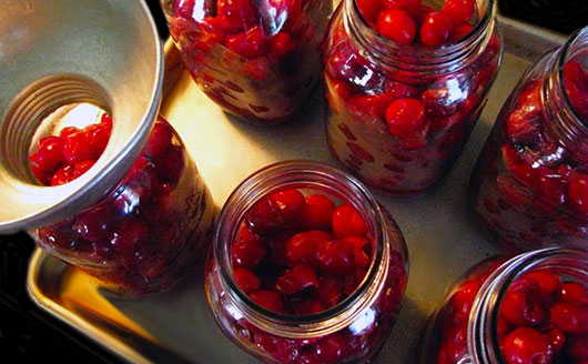 Canned cherries in glass jars
