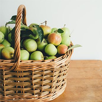 Photo of green apples in a basket.