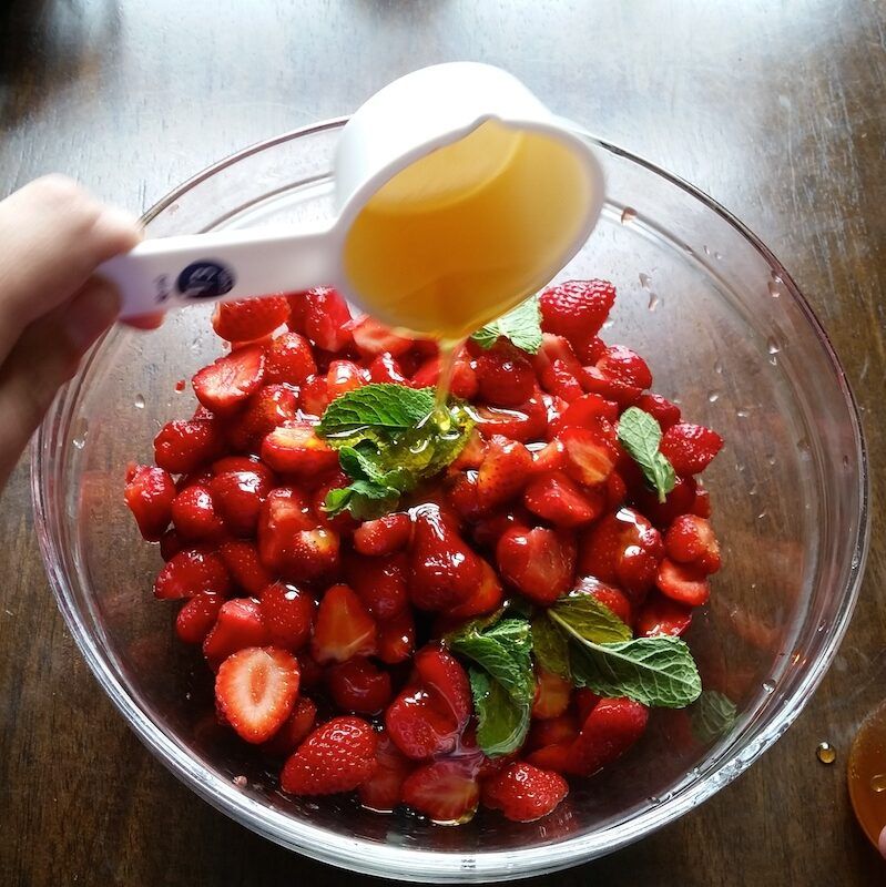 Pouring Honey on Strawberry Mixture