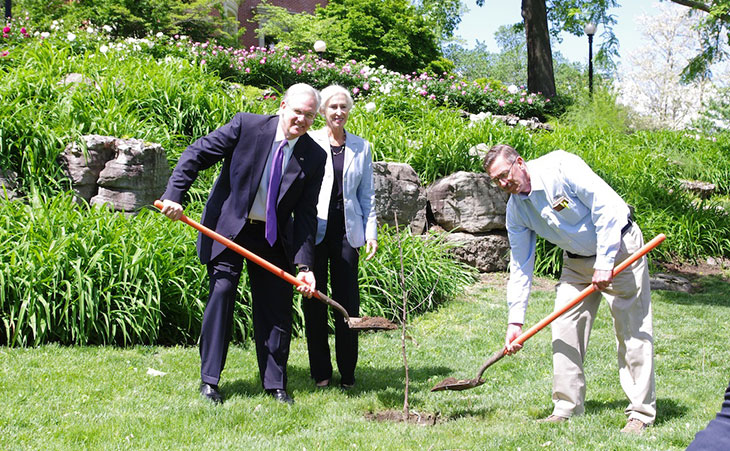 three people planting tree at Missoui Governor's Place