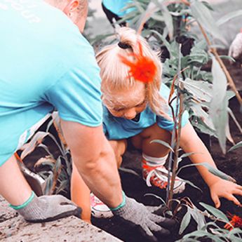 Child and Parent planting something