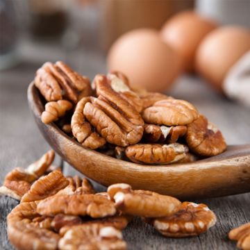 shelled pecans in spoon