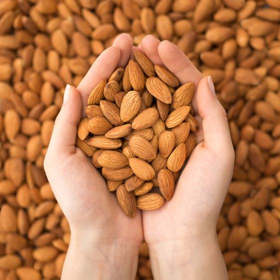 Lots of almonds, some in hands