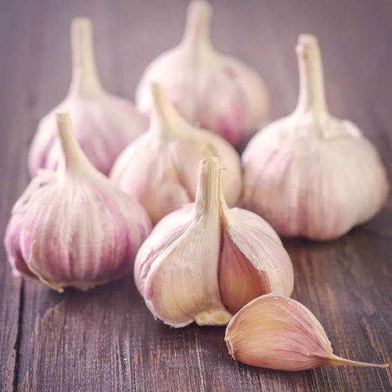 Garlic open with red purple streaking on cloves