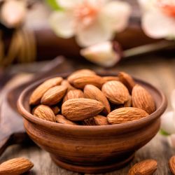 almonds in a bowl with blooms in the background