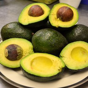Avocados in bowl, some cut open