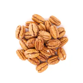 Freshly shelled pecans on white surface