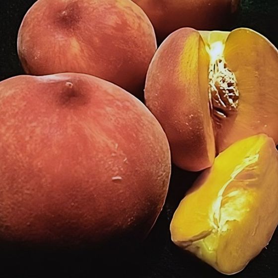 Ripe peaches, whole and sliced.