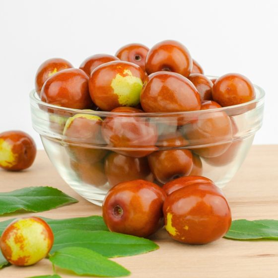 brown and green jujubes in bowl on counter