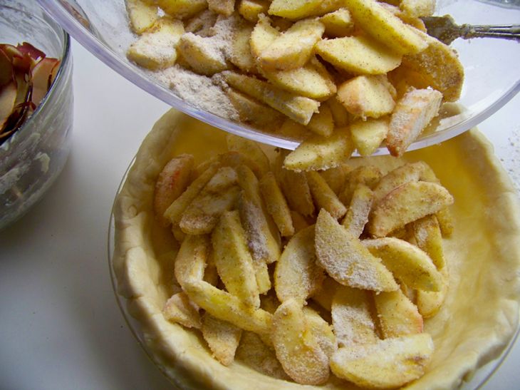 Pie Crust Being Filled with Apples