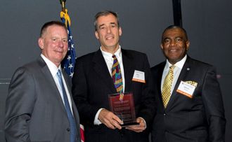 Three gentlemen, receiving award