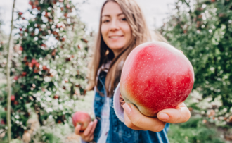 woman holding apple