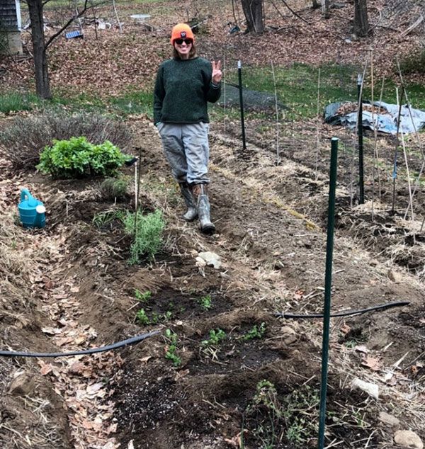 A person standing in an herb garden