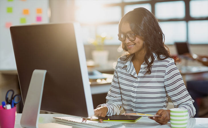 Woman sitting a desktop computer