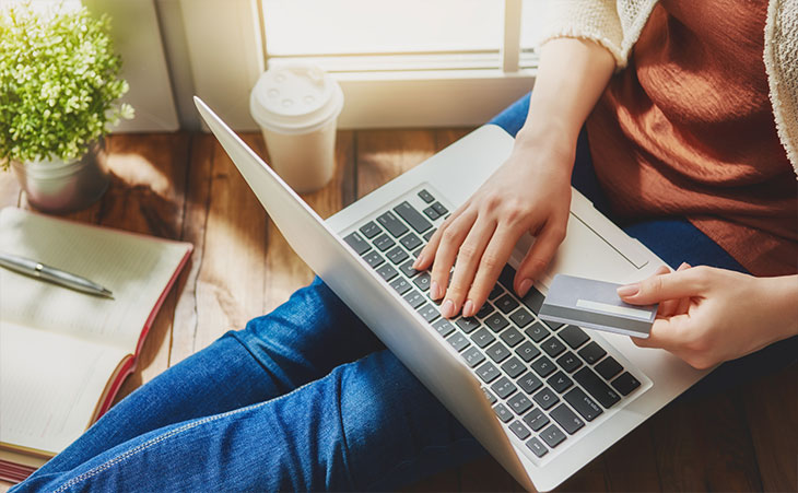 Photo of someone using a laptop to make an online purchase